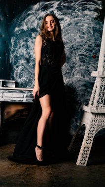 Stüdyoda dantel elbiseyle poz veren genç ve güzel bayan.  