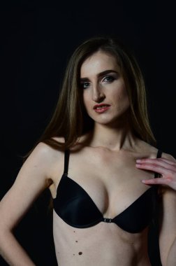 Sarı ceketli, şortlu ve topuklu ayakkabılı zarif bir kadın. Moda stüdyosu çekimi.