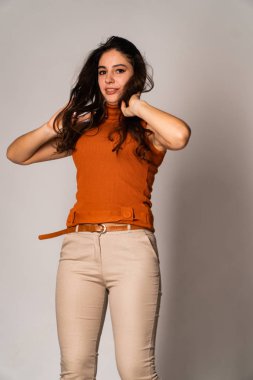 Güzel esmer model, karanlık odada poz veriyor. 