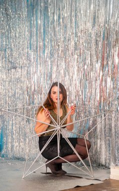 Stüdyoda poz veren parlak noel süsleriyle güzel seksi kadın, tatil konsepti.   