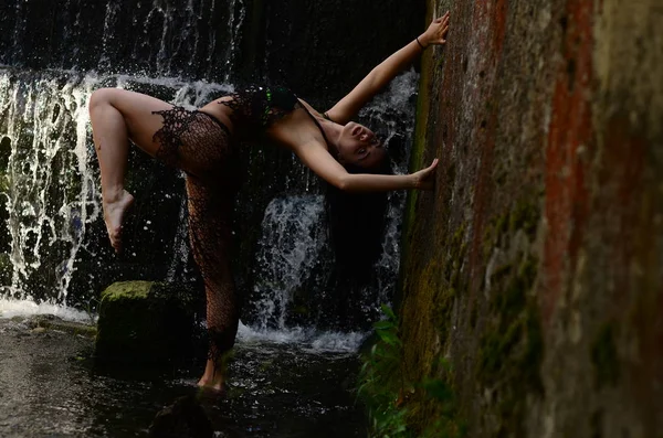 Joven modelo morena posando contra una cascada —  Fotos de Stock