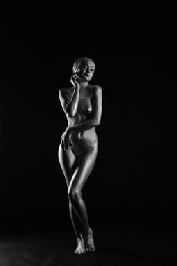 Gümüş rengi vücut boyalı genç atletik kadın.