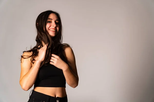 Portrait of disconcerted young woman in light clothes looking aside covering nose with hand isolated on white wall background in studio. People sincere emotions, lifestyle concept. Mock up copy space — Stock Photo, Image