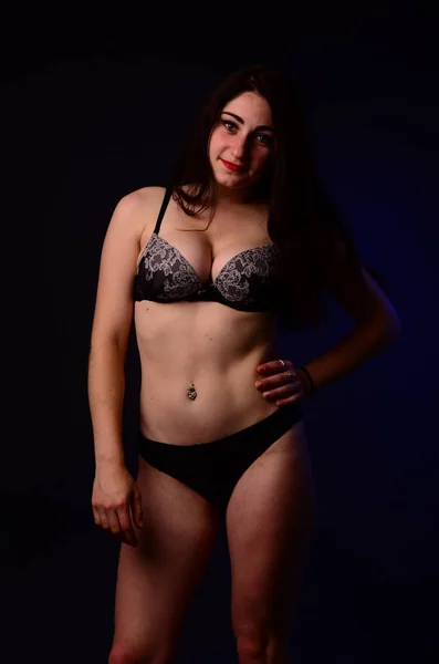 Sexy brunetka v ložním prádle pyžamu, pózování ve studiu, tmavé fotky, e — Stock fotografie