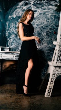 Stüdyoda dantel elbiseyle poz veren genç ve güzel bayan.  