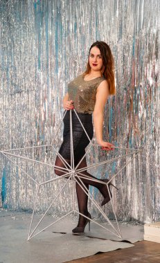 Stüdyoda poz veren parlak noel süsleriyle güzel seksi kadın, tatil konsepti.   