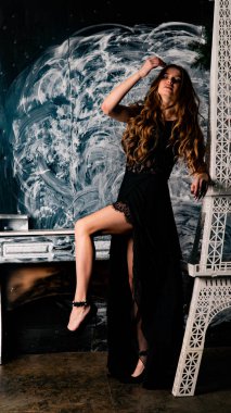 Stüdyoda dantel elbiseyle poz veren genç ve güzel bayan.  