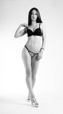 Beyaz arka planda siyah iç çamaşırlı güzel seksi kadın.