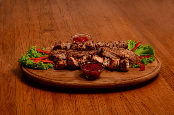 Grilled meat and vegetables on rustic wooden table