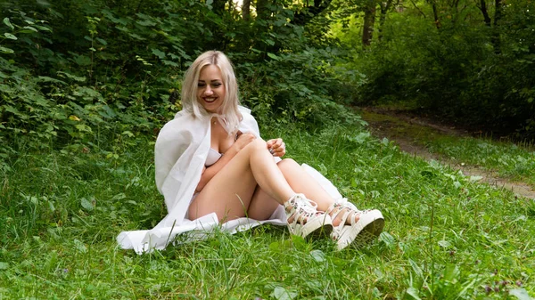 Beautiful sexy blonde woman, the image of a nun in a white raincoat — Stock fotografie
