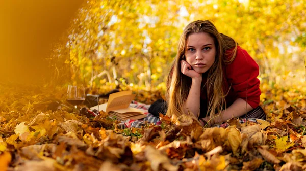 Incredible stunning girl in a red dress. The background is fantastic autumn. Artistic photography. — Stock Photo, Image