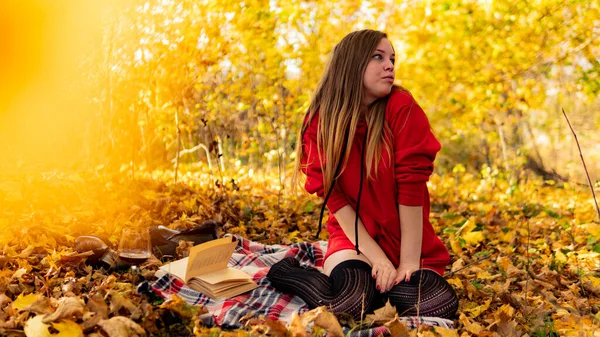 Incredible stunning girl in a red dress. The background is fantastic autumn. Artistic photography. — Stock Photo, Image