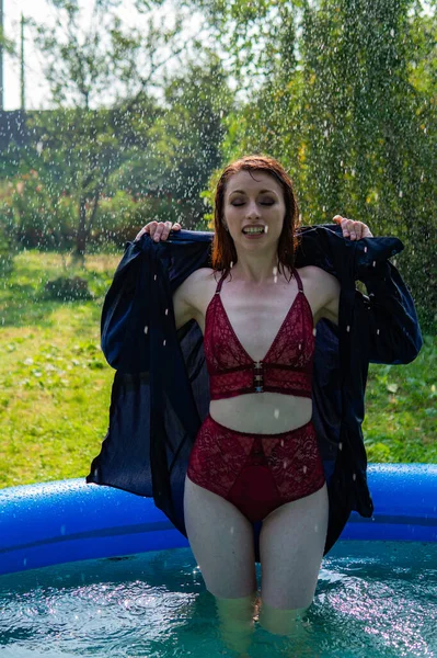 Mujer desnuda, cabello rojo húmedo, naturaleza, piscina — Foto de Stock