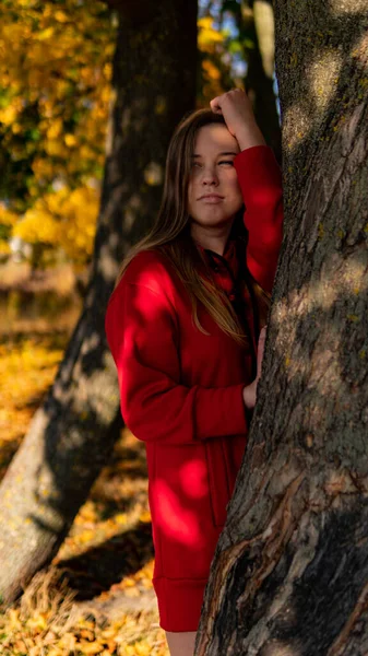 stock image Incredible stunning girl in a red dress. The background is fantastic autumn. Artistic photography.