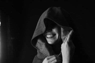 Kırmızı pelerinli güzel bir kadın elinde mum tutuyor. Dramatik ve fantastik atış. 