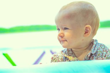 little girl playing in inflatable swimming pool 