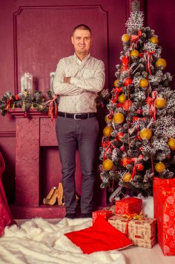 Noel süslemelerinde mutlu bir gencin portresi. 
