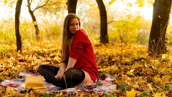 Incredible stunning girl in a red dress. The background is fantastic autumn. Artistic photography. — Stock Photo, Image