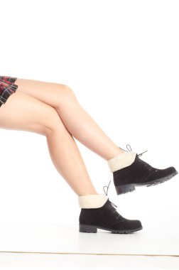 Gri arka planda yüksek topuklu giyen ince kadın bacakları. Vücut giysisi içinde mükemmel vücut