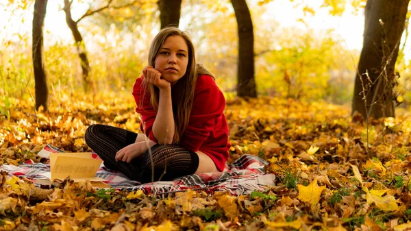 Incredible stunning girl in a red dress. The background is fantastic autumn. Artistic photography. — Stock Photo, Image