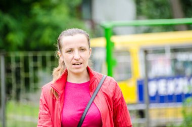 Şehrin arka planında sırt çantası olan güzel bir genç kadının portresi.