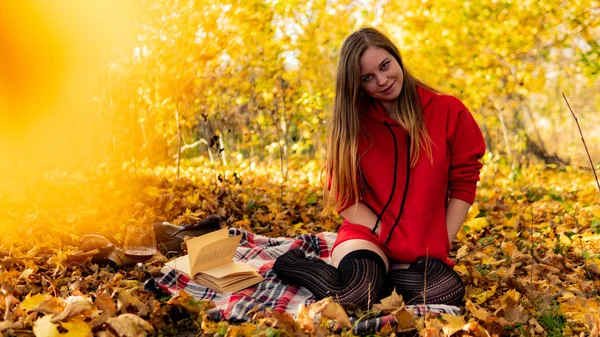 Incredible stunning girl in a red dress. The background is fantastic autumn. Artistic photography. — Stock Photo, Image