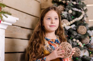 Noel süslemeli stüdyoda poz veren güzel küçük kız. 