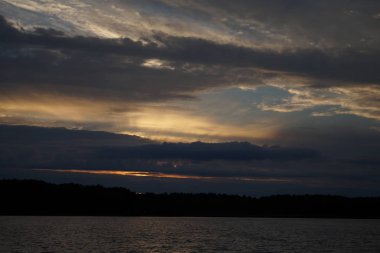 Sabahın erken saatlerinde gölün üzerinde sonsuz karanlık gökyüzü manzarası.   