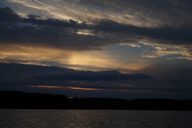 Sabahın erken saatlerinde gölün üzerinde sonsuz karanlık gökyüzü manzarası.   