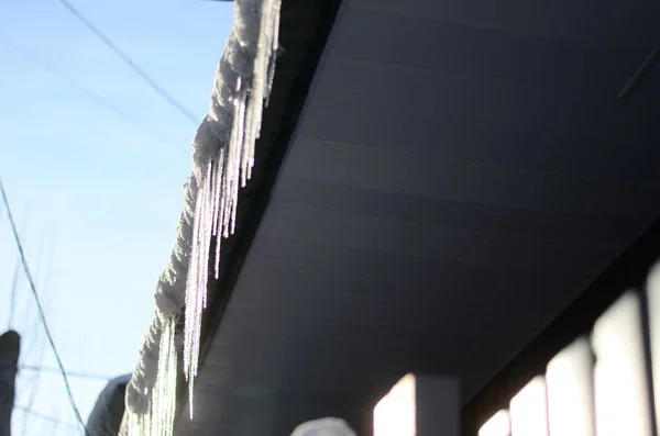icicles which are hanging down from a roof