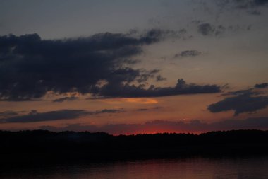 Sabahın erken saatlerinde gölün üzerinde sonsuz karanlık gökyüzü manzarası.   