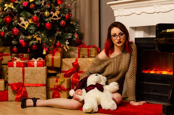 Ein junges schönes Mädchen mit einem Glas Champagner und einer Flasche von ihr beim Neujahrs-Fotoshooting im Studio. das Neujahrskonzept. — Stockfoto