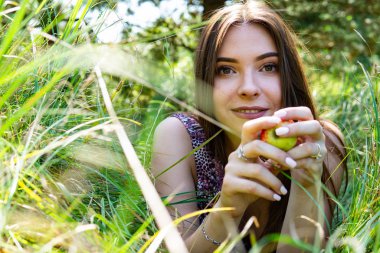 Gölün oradaki tahta iskelede poz veren siyah saçlı kadın. Sırtı Neusiedl Gölü 'nün tahta yaya köprüsüne dönmüş bir kadın. Arka plandaki kayıkhanede güneş yansımaları.
