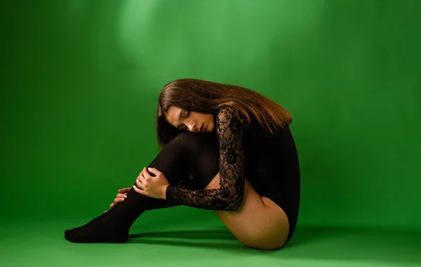 Menina em preto bodysuit no fundo verde — Fotografia de Stock