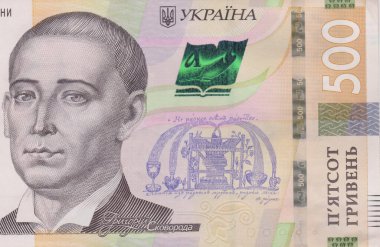 A lot of Ukrainian hryvnias, face value 500 hryvnias on a black background, nicely laid out money on black