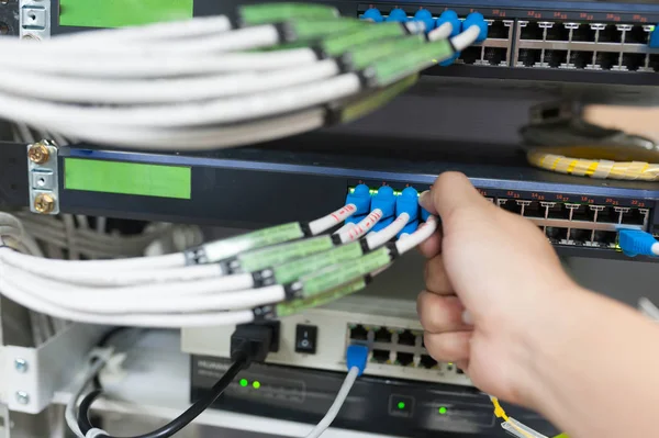 People fix core switch in network room