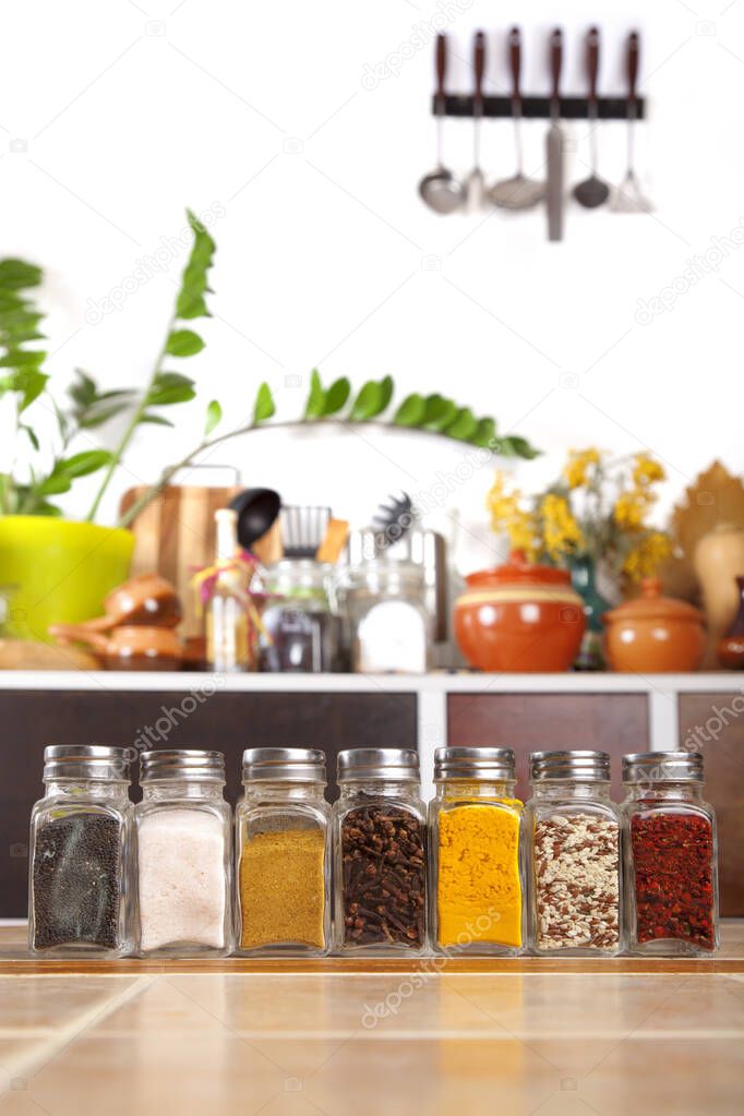 Jars of spices on the table in the kitchen