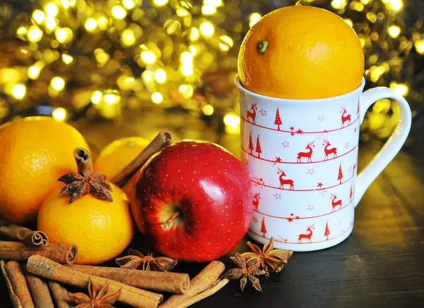 Christmas cup and fruits in front of a luminous background — Stock Photo, Image