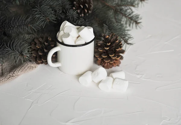 Cup of cacao with a marshmallows on a wooden background