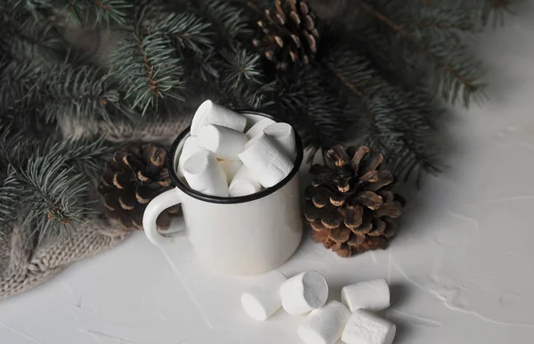 Cup of cacao with a marshmallows on a wooden background