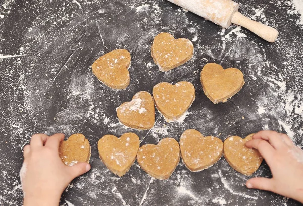 Homemade hearts cookies on a black background