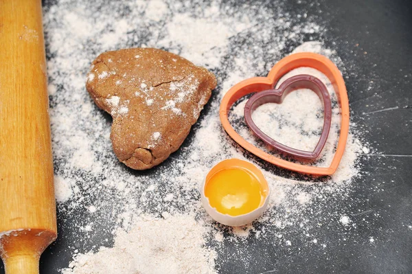 Homemade heart cookies on a black background