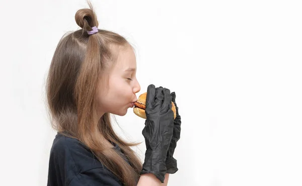 Schattig Klein Meisje Met Zwart Handschoenen Eet Hamburger — Stockfoto