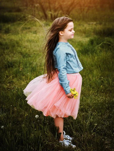 在黑暗的草地上独自微笑着的小女孩 — 图库照片