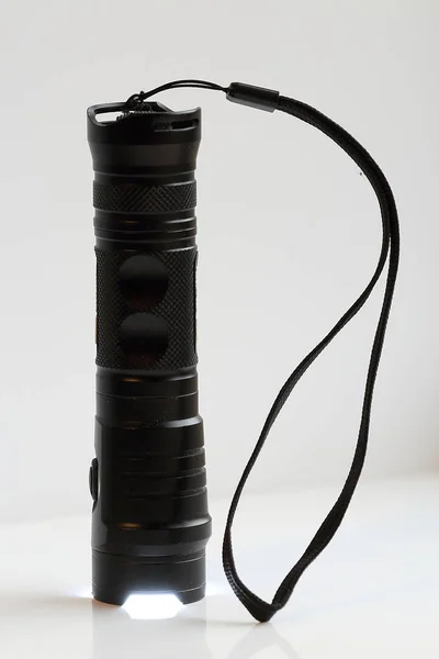 Manual black flashlight, reliability, quality, shine — Stock Photo, Image