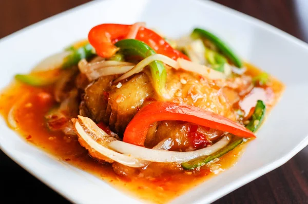 Red Hot Snapper, Fried red snapper fillet topped with hot peppers, onions, fresh garlic & bell peppers mixed in sweet & sour sauce