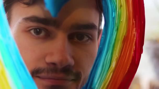 一个留着胡子和彩虹的人隔离结束了彩虹是心形的 在玻璃上呼吸 — 图库视频影像