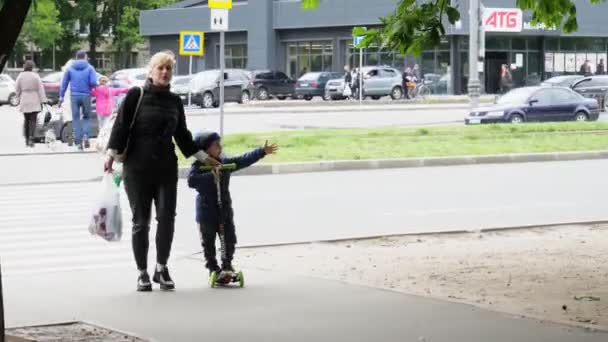 子供のいるお母さんが通りを歩いている 隔離の終わり — ストック動画