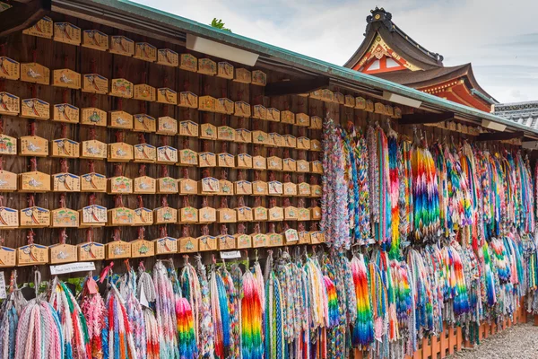 Prayer boards and strings of origami cranes.