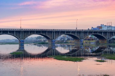 Blue purple morning sky over bridge in Madurai. clipart